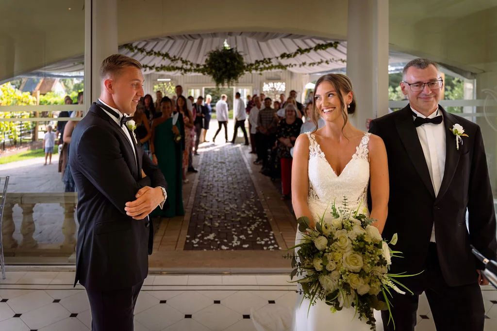 A bride and groom walking down the aisle.
