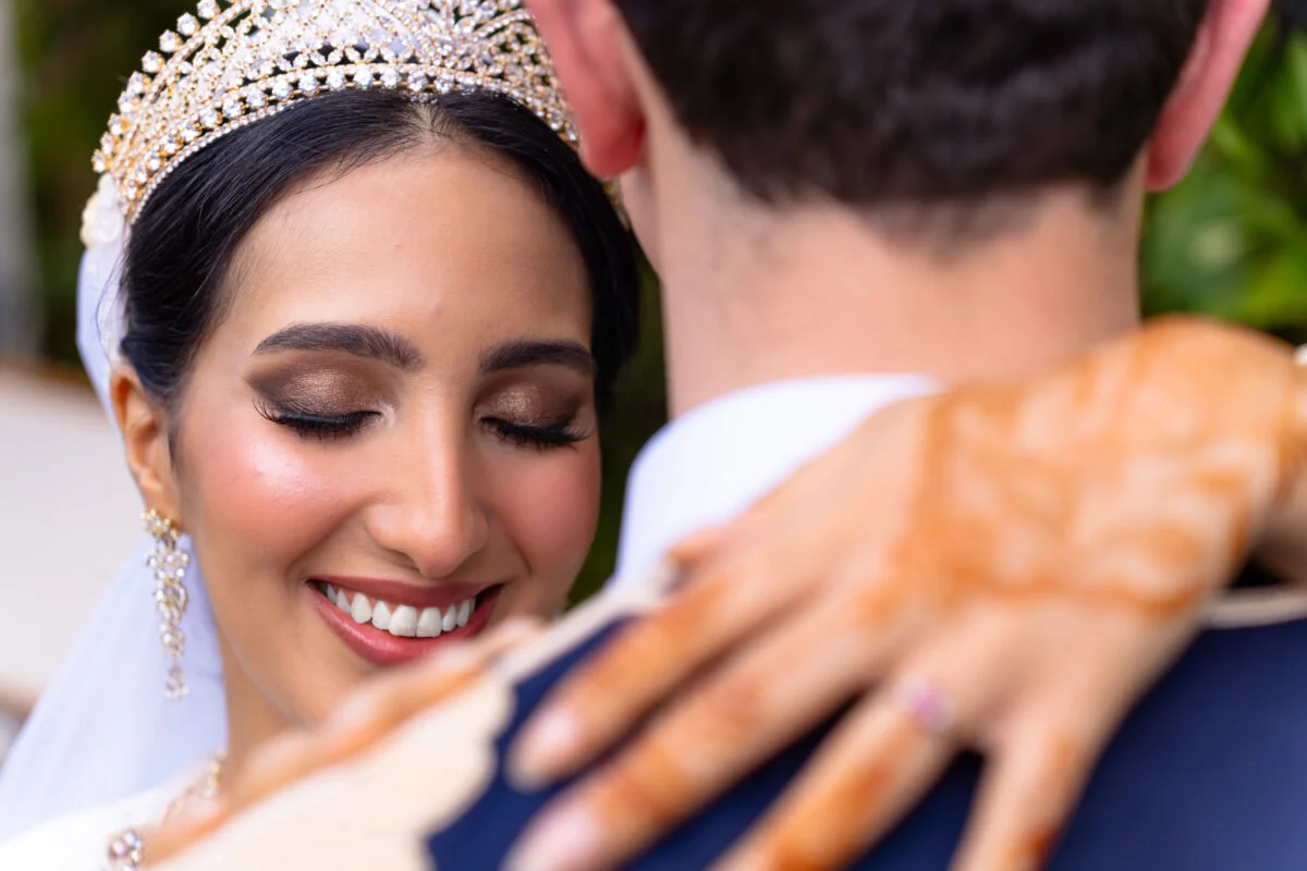 A bride and groom hugging each other on their wedding day.