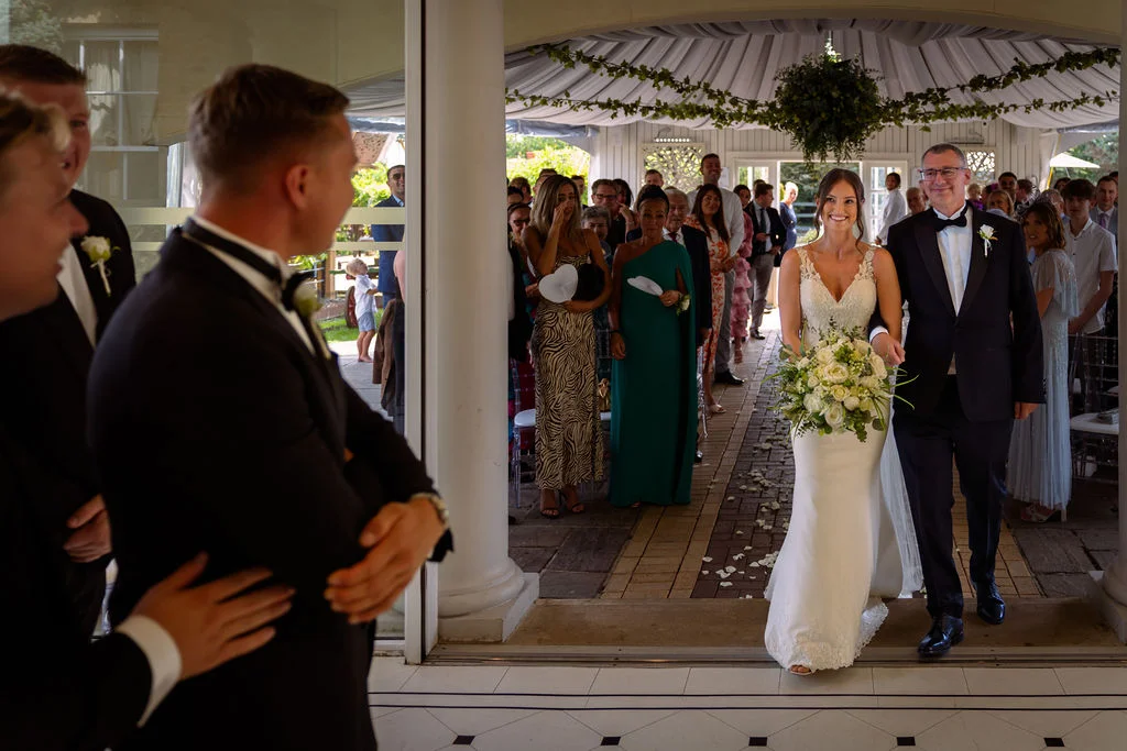A bride and groom walking down the aisle.
