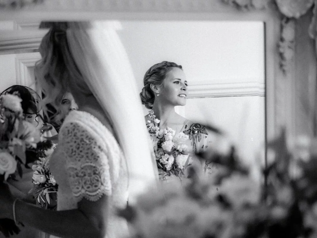 A bride looking at herself in a mirror.