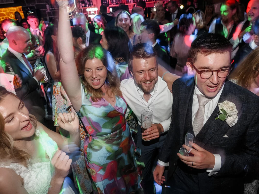 A group of people dancing at a party.