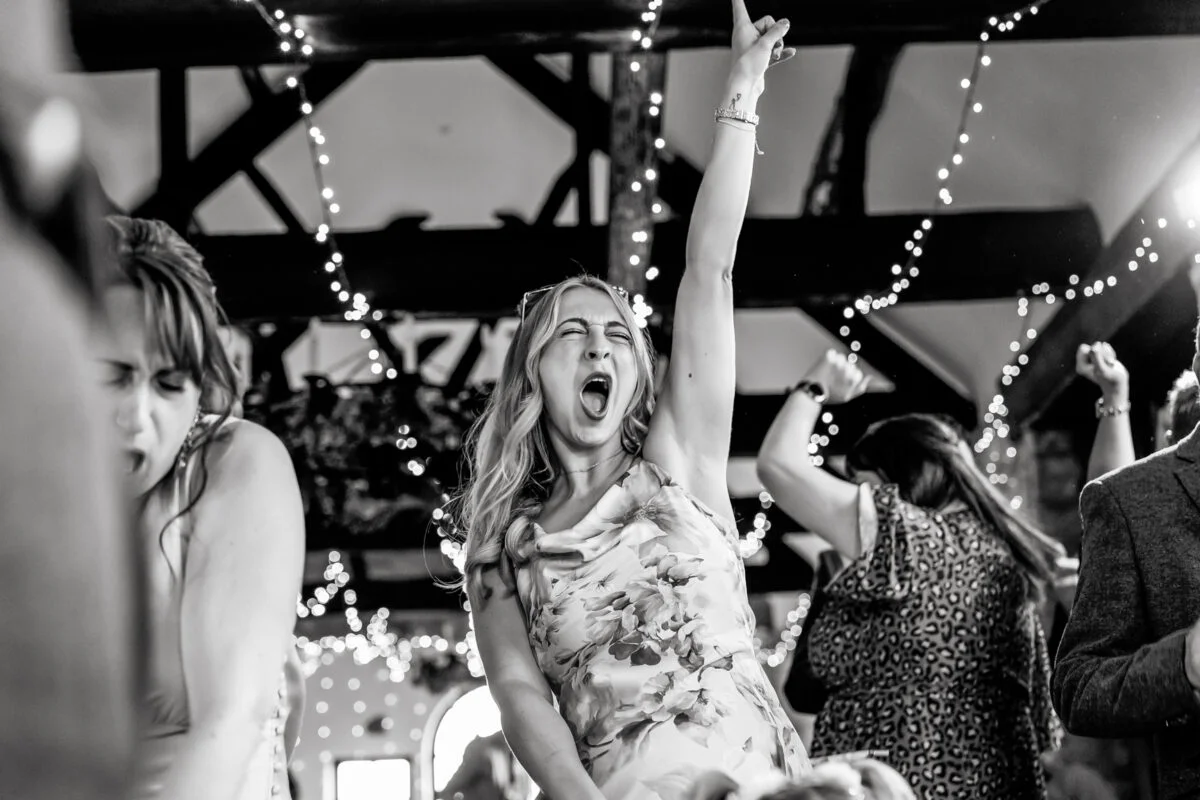 Black and white photo of a woman dancing on a dance floor.