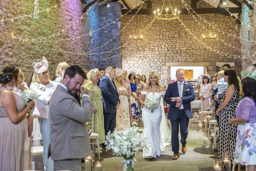 A bride and groom walking down the aisle at a wedding.