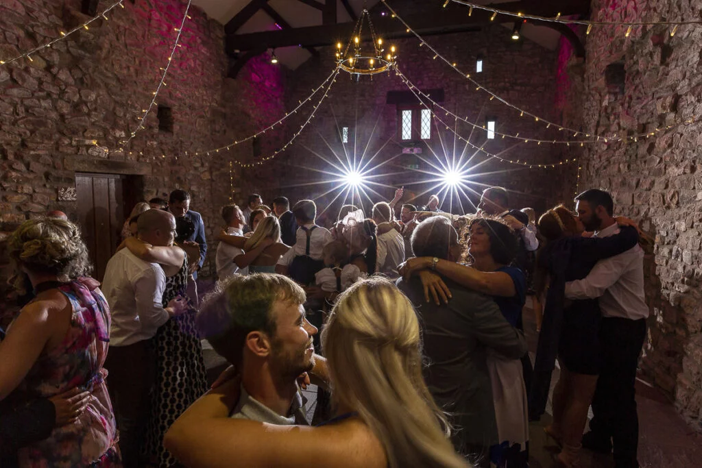 A group of people dancing in a dark room.