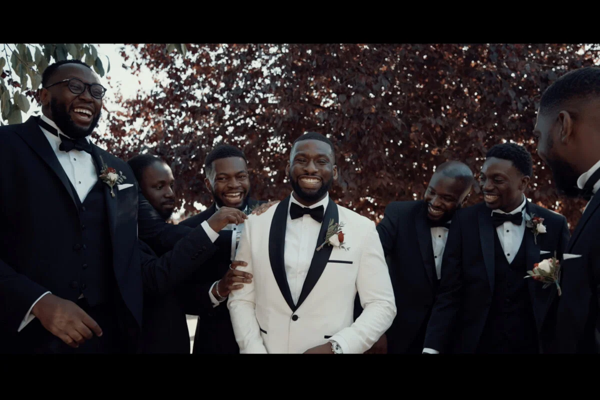A group of groomsmen in tuxedos and tuxedos.