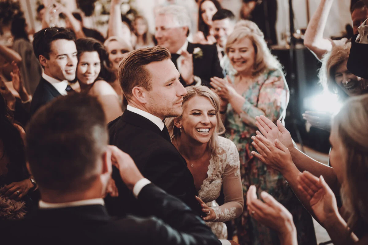 A bride and groom dance at a wedding reception.