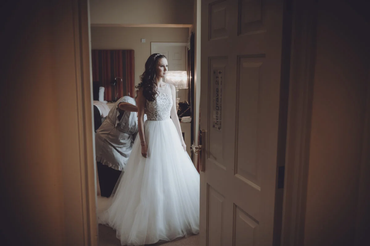 A bride is getting ready in a hotel room.