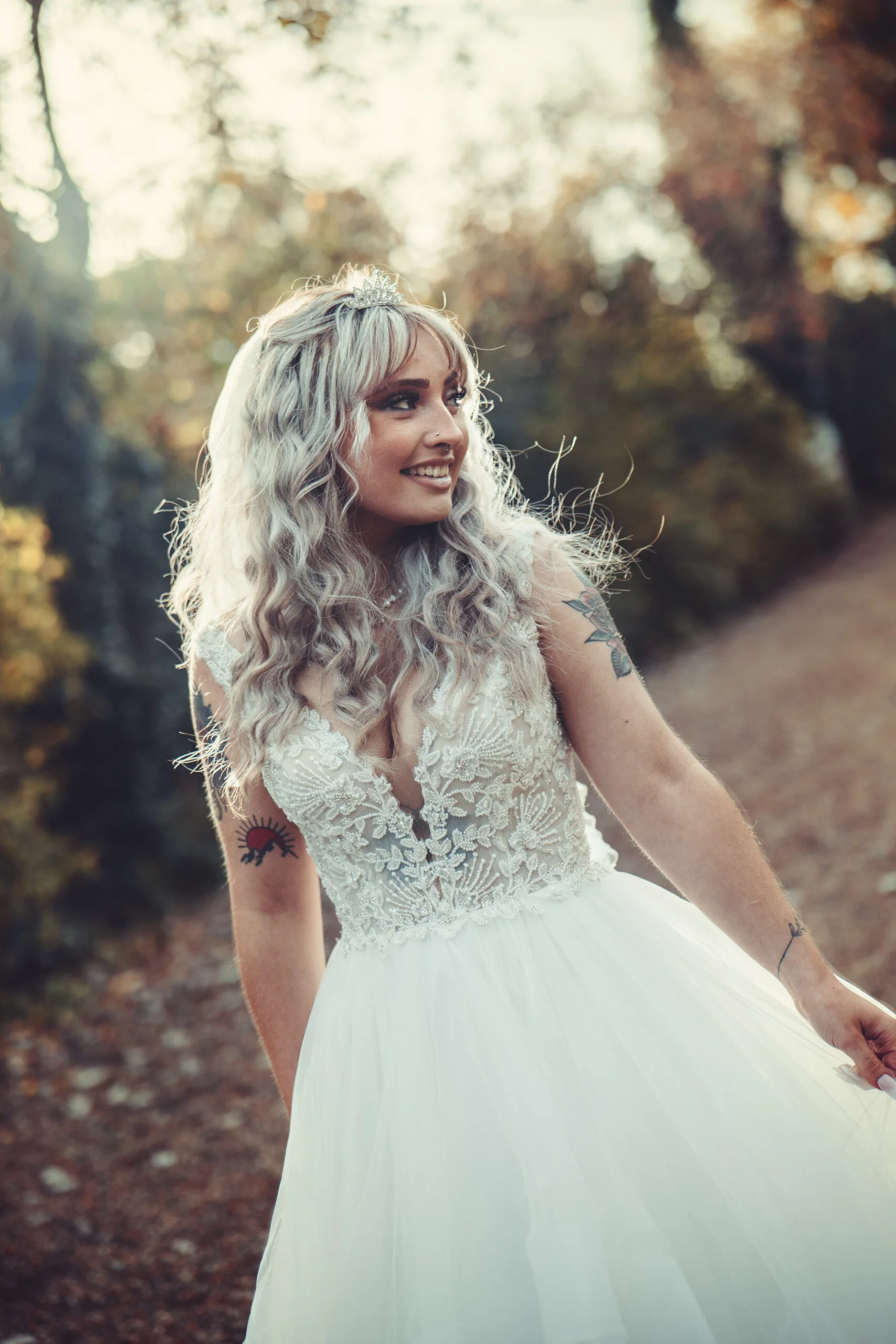 A bride in a wedding dress walking down a path. (listing)