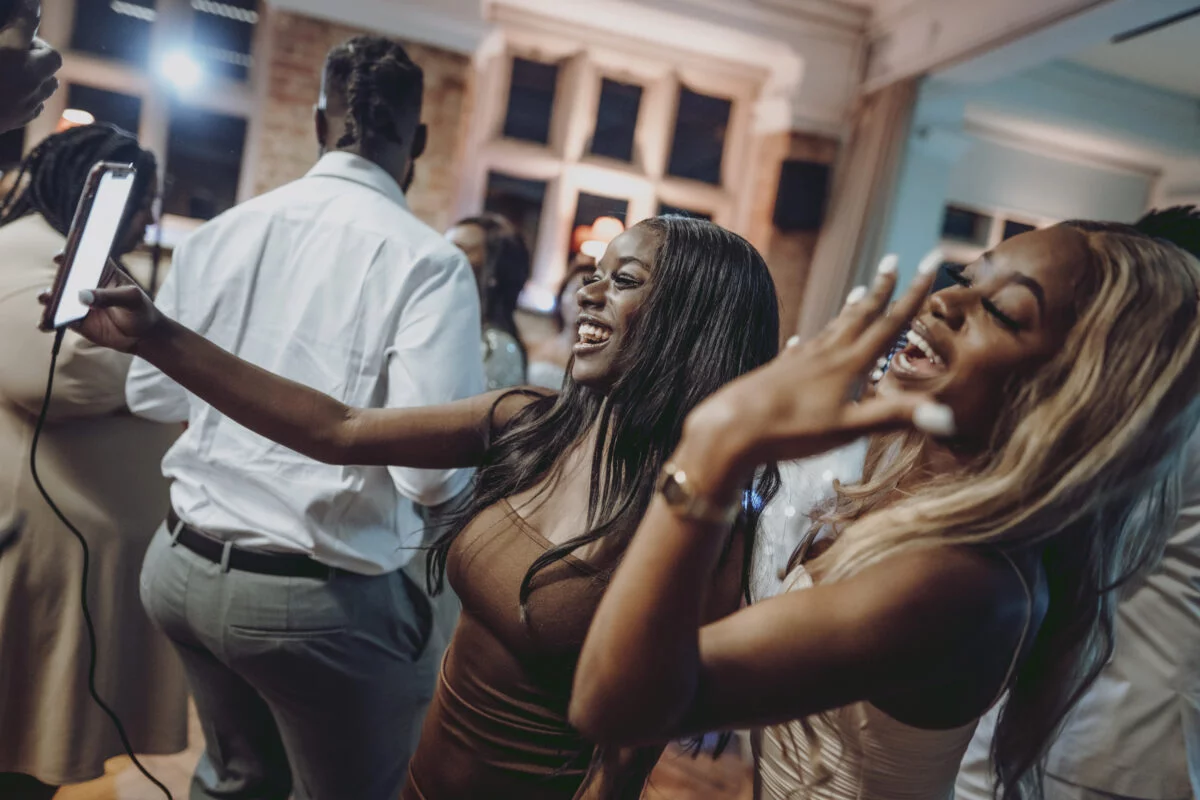 A group of people taking a selfie at a party.