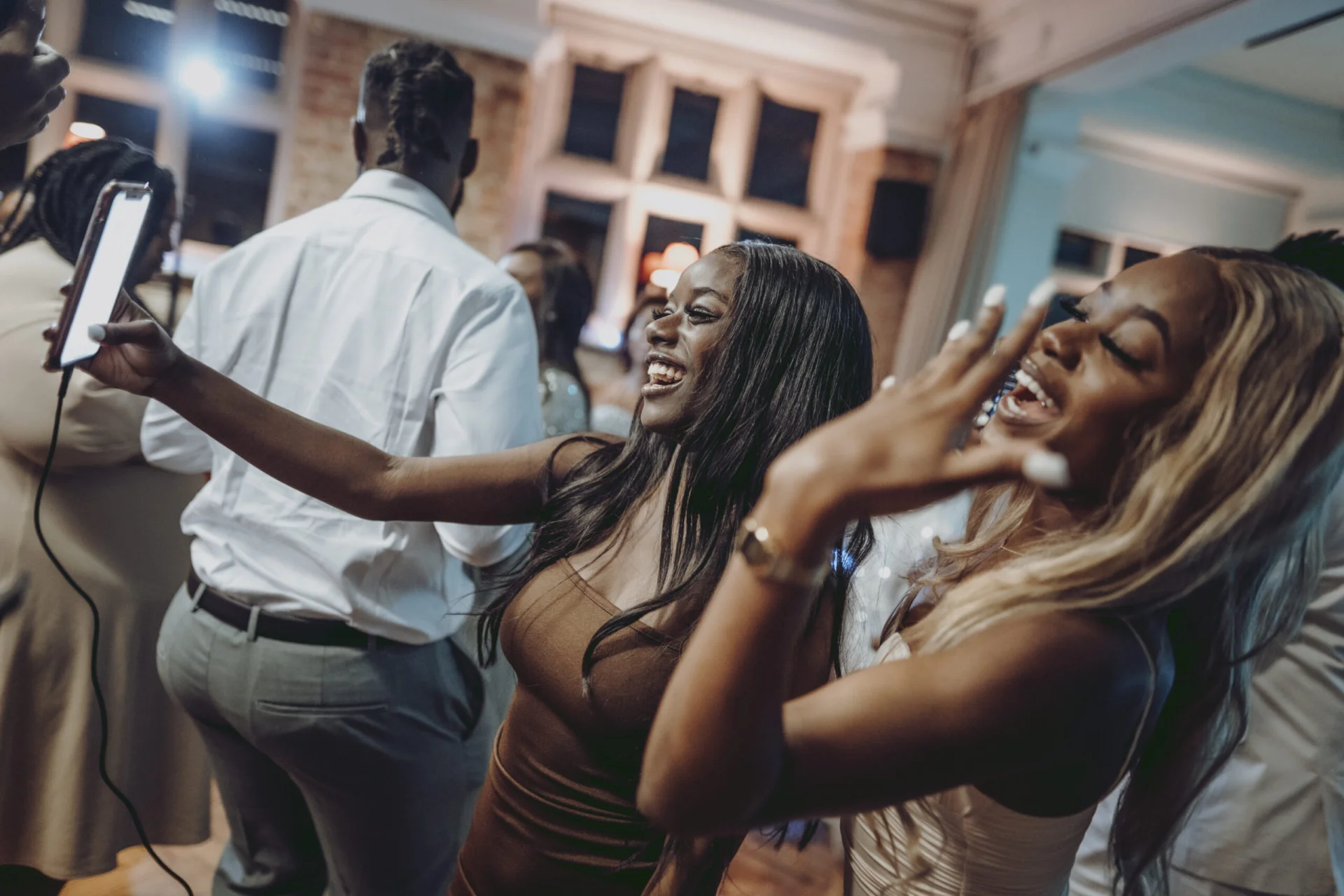 A group of people taking a selfie at a party. (listing)