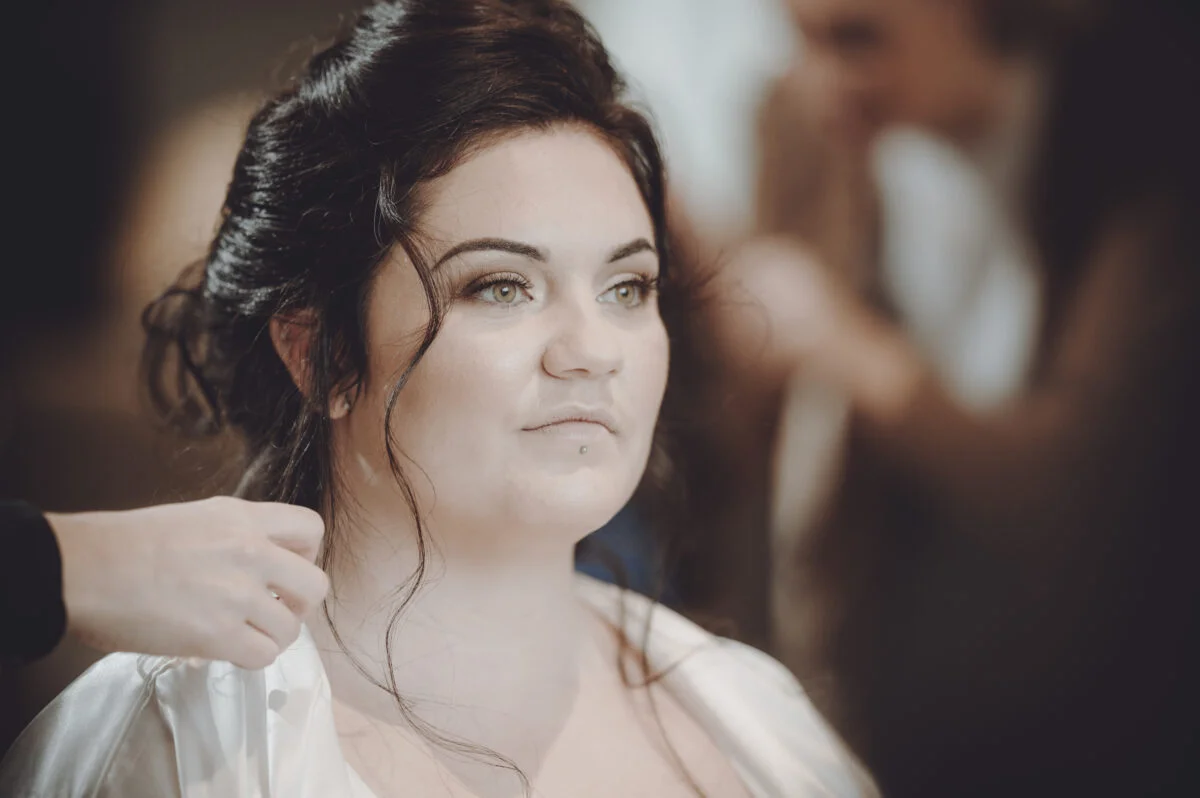 A bride getting her hair done by a hairdresser.