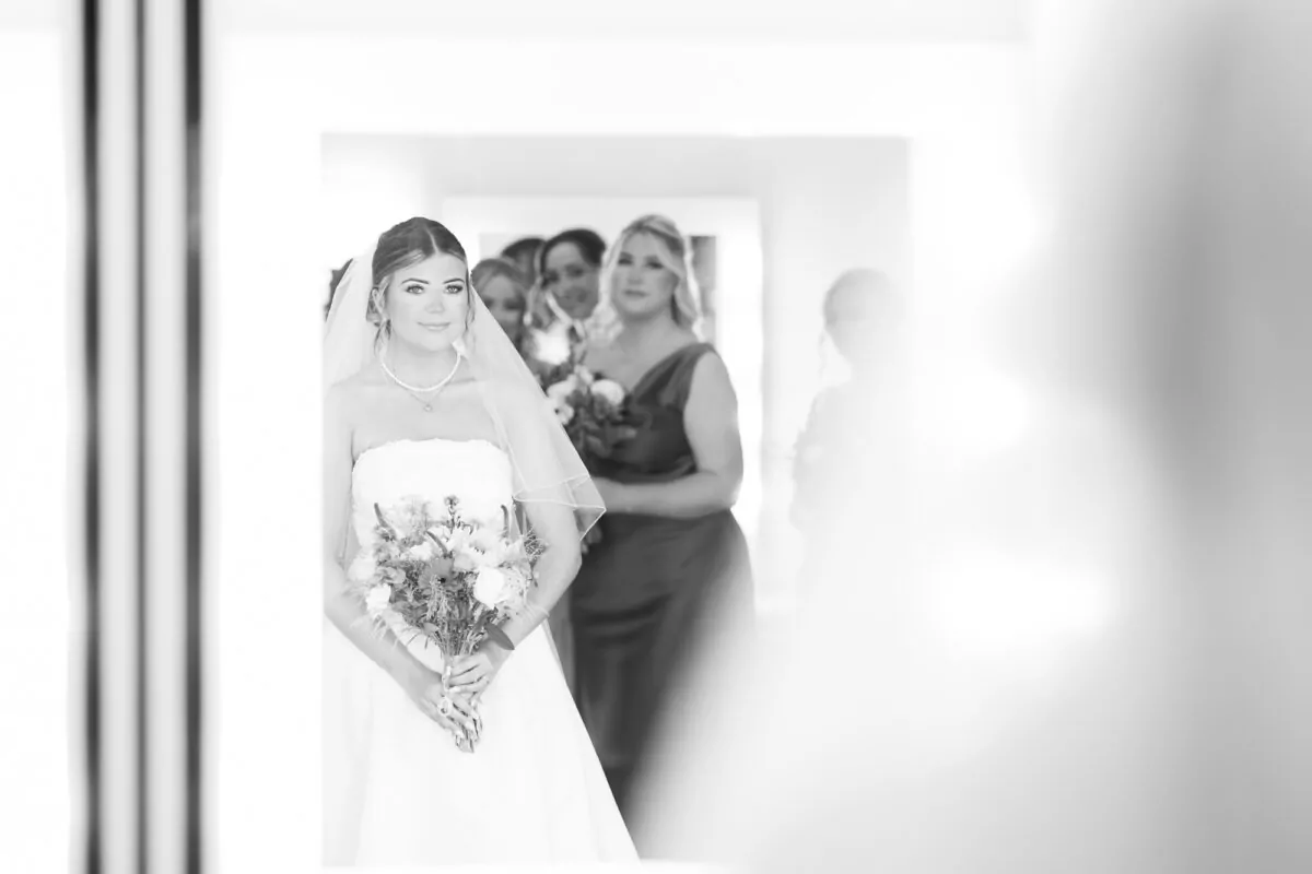 5 Bride looking in Mirror with bridesmaids