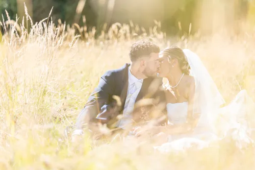 1 Bride and Groom kiss in long grass
