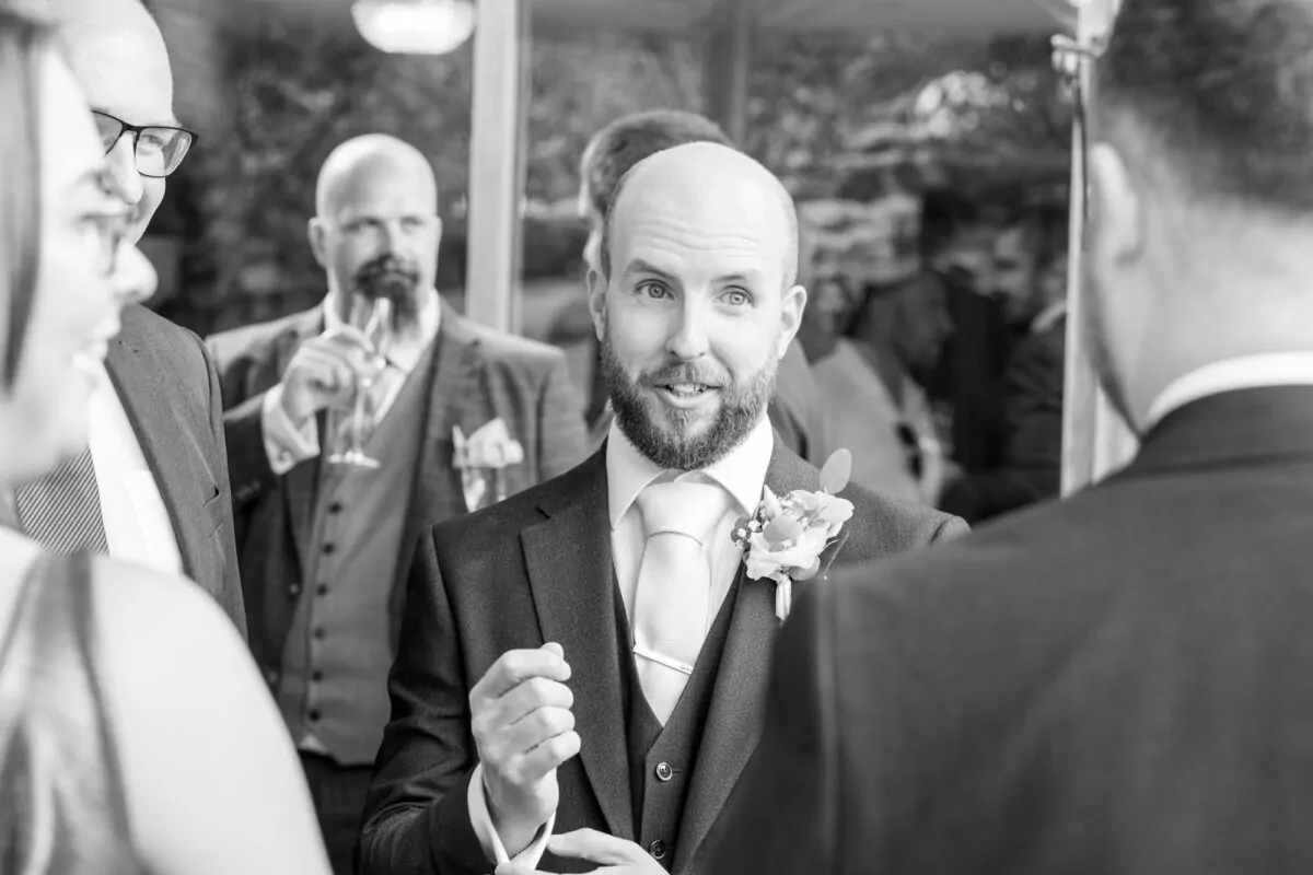 Groom chatting with guests