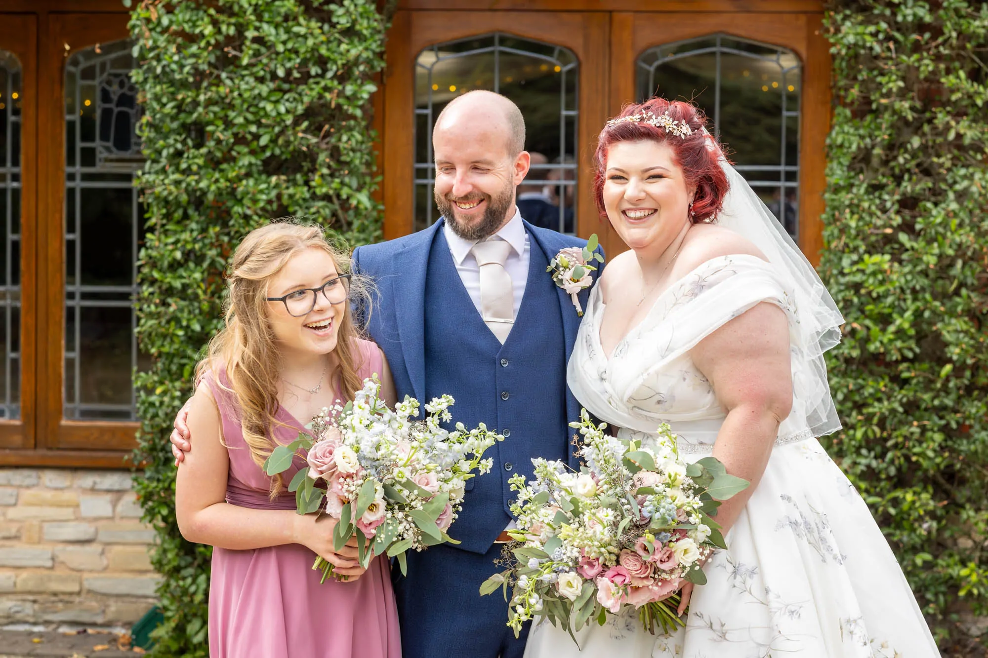 bride and groom having fun with daughter
