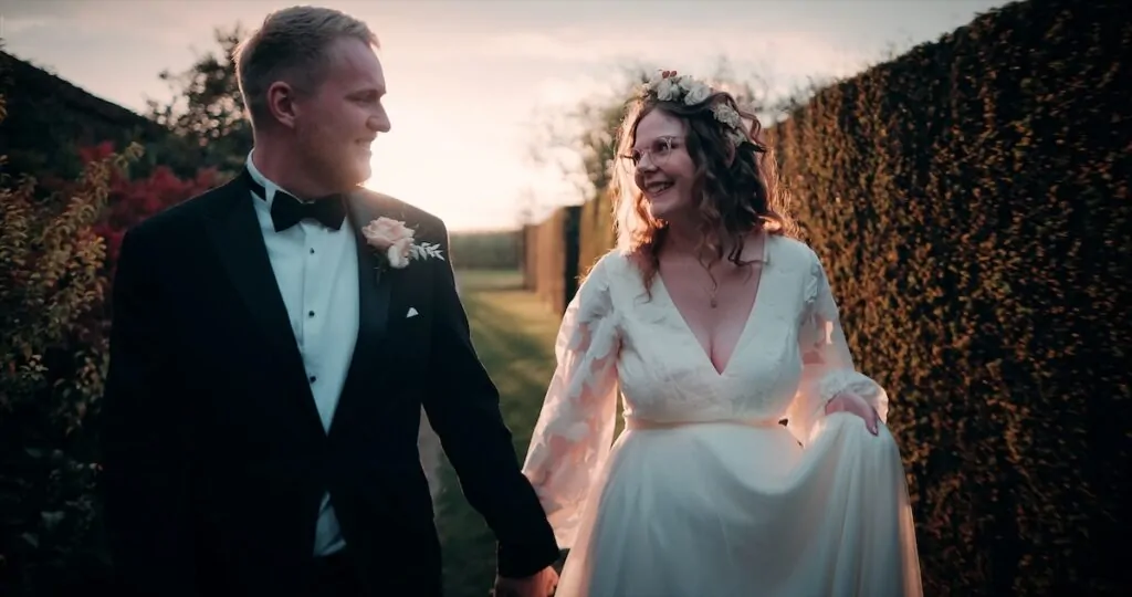 couple walking sun behind