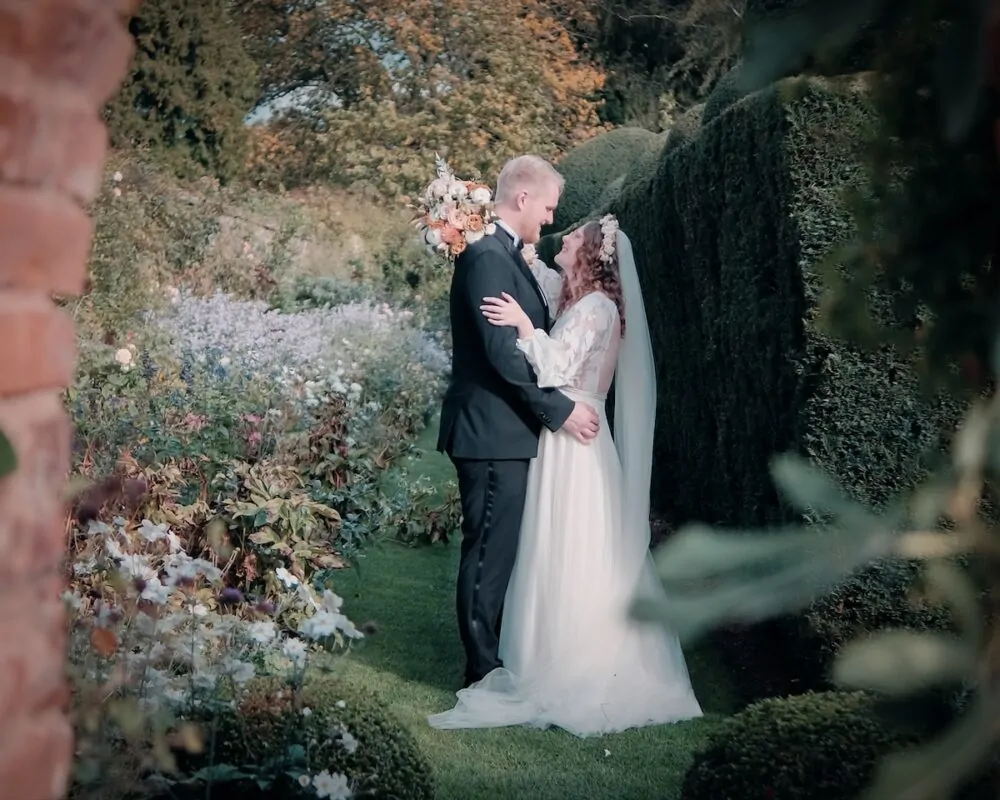 couple garden embrace through archway