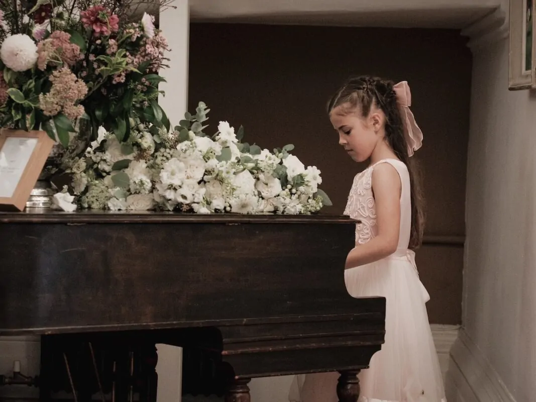 Flower girl plays piano