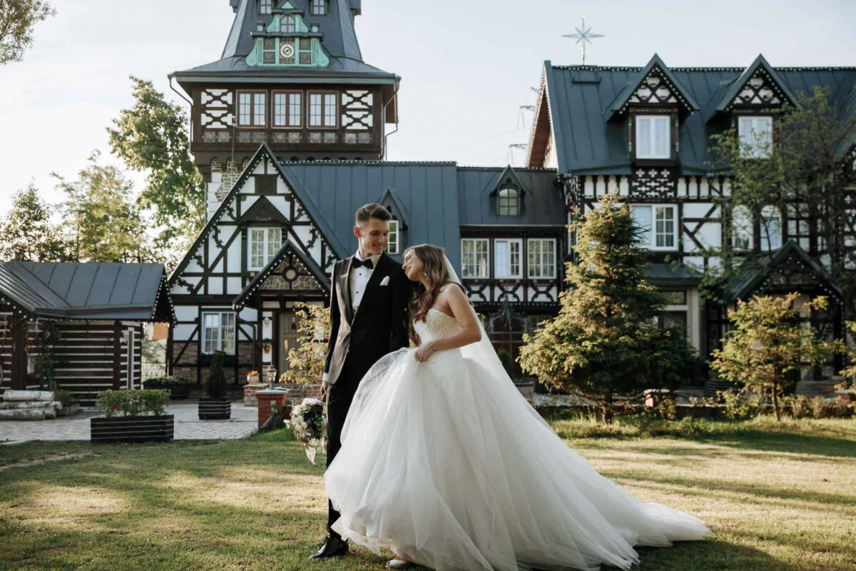 Bride and Groom Walk in front of Beautiful House