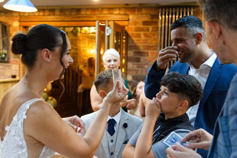 wedding magician doing magic trick on bride and groom