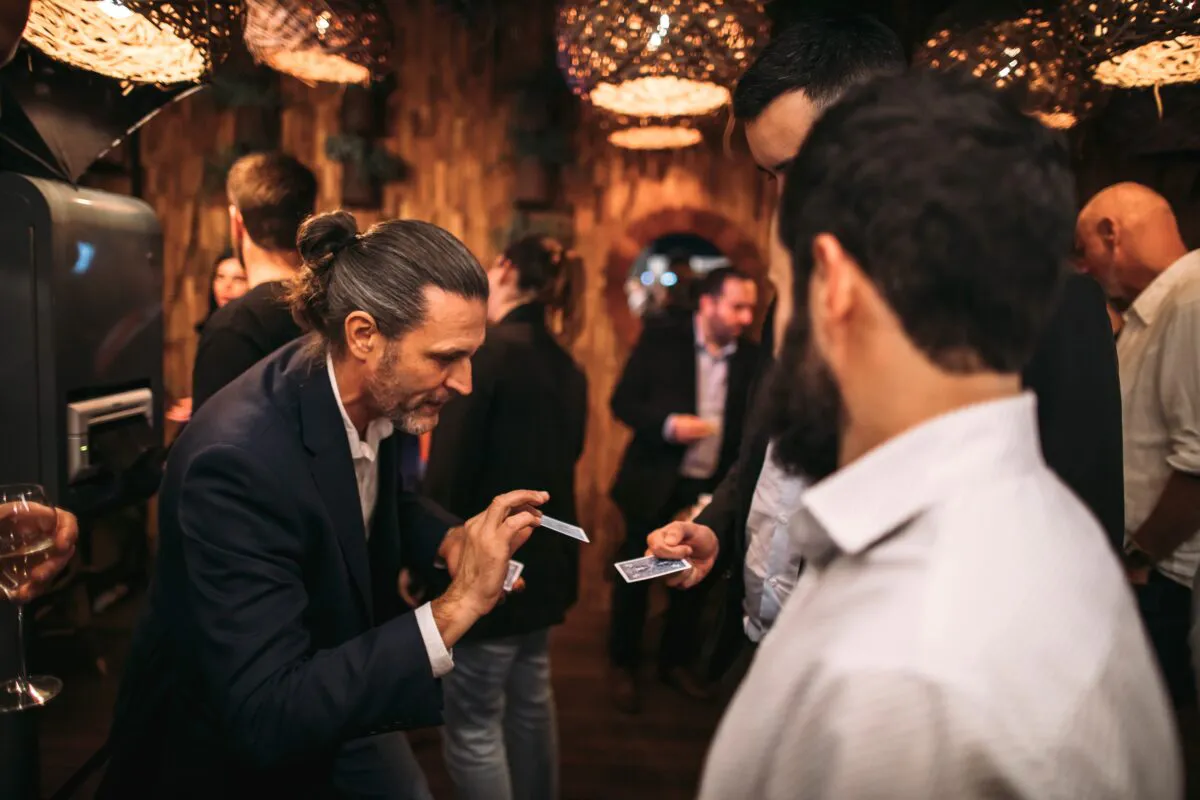 Corporate magician performing some strolling magic at event
