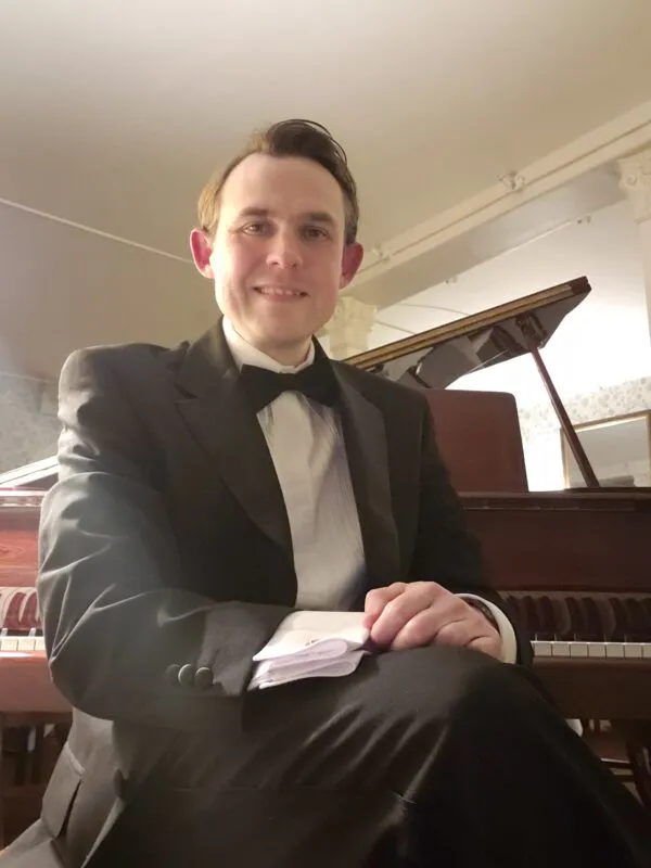 Sat at piano 2022 reversed (corrected)