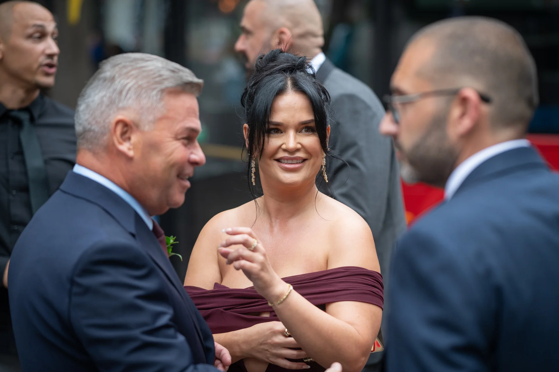 Wedding guests mingling and smiling together in a candid moment during the drinks reception.